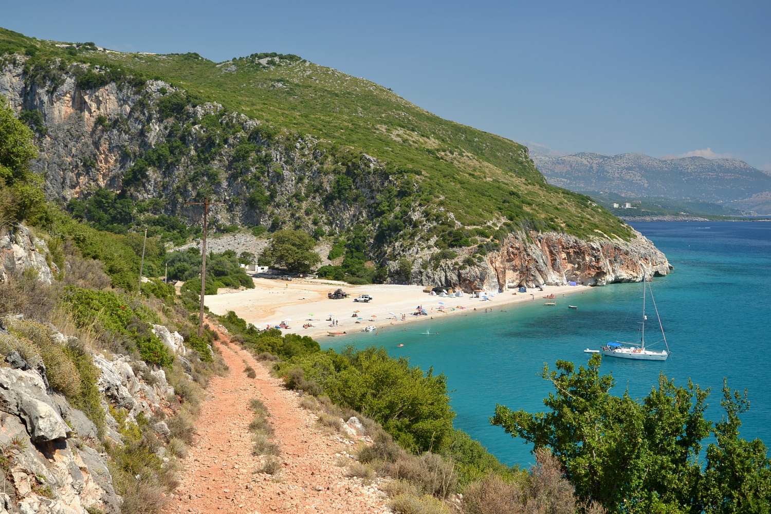 Gjipe Beach Albania — dramatic canyon walls frame this hidden cove accessible by hike or boat