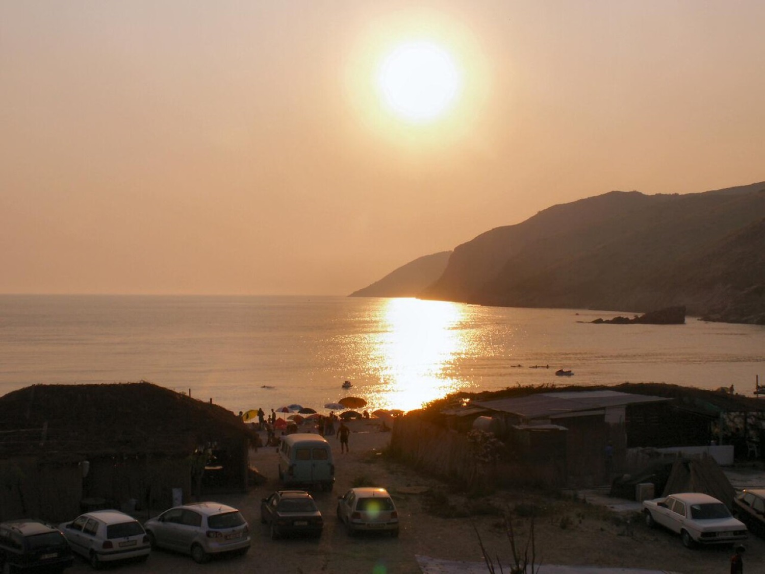 Jale Beach Albania — compact pebble and sand cove with olive groves and turquoise Ionian water