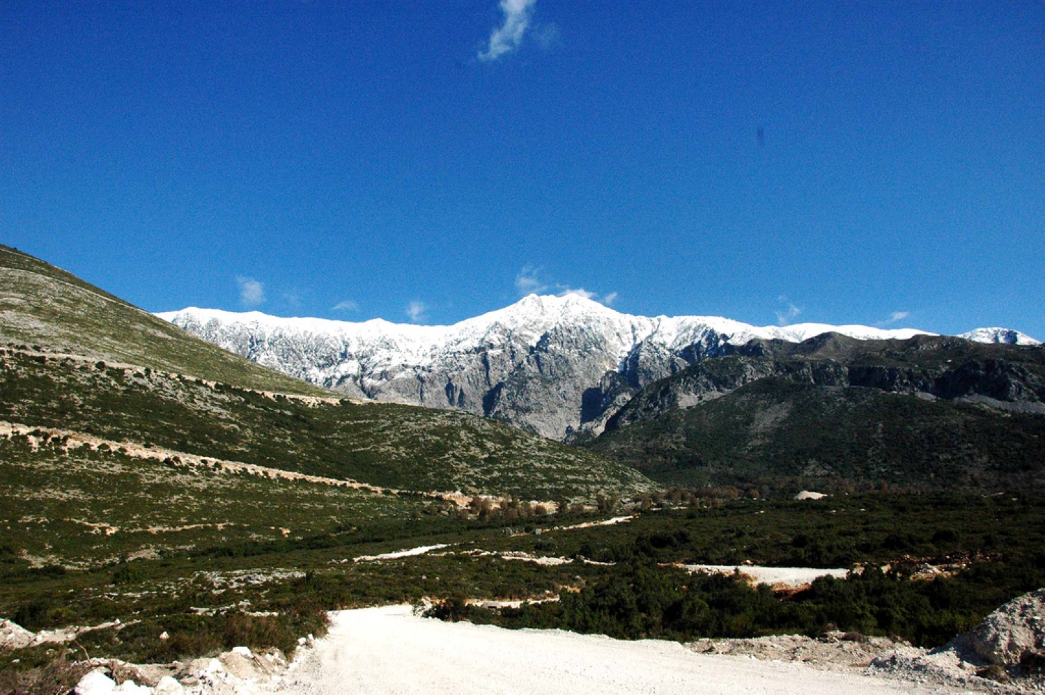 View from Palasë Beach toward Maja Çika — limestone cliffs of the Ceraunian Mountains above the Ionian