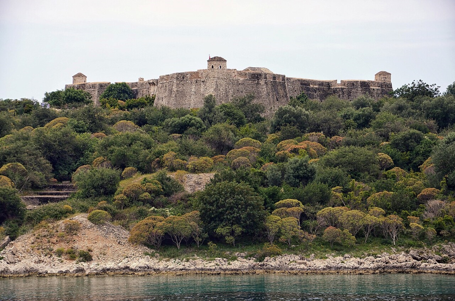 Porto Palermo Castle Albania — the limestone fortress on its triangular peninsula surrounded by the calm bay