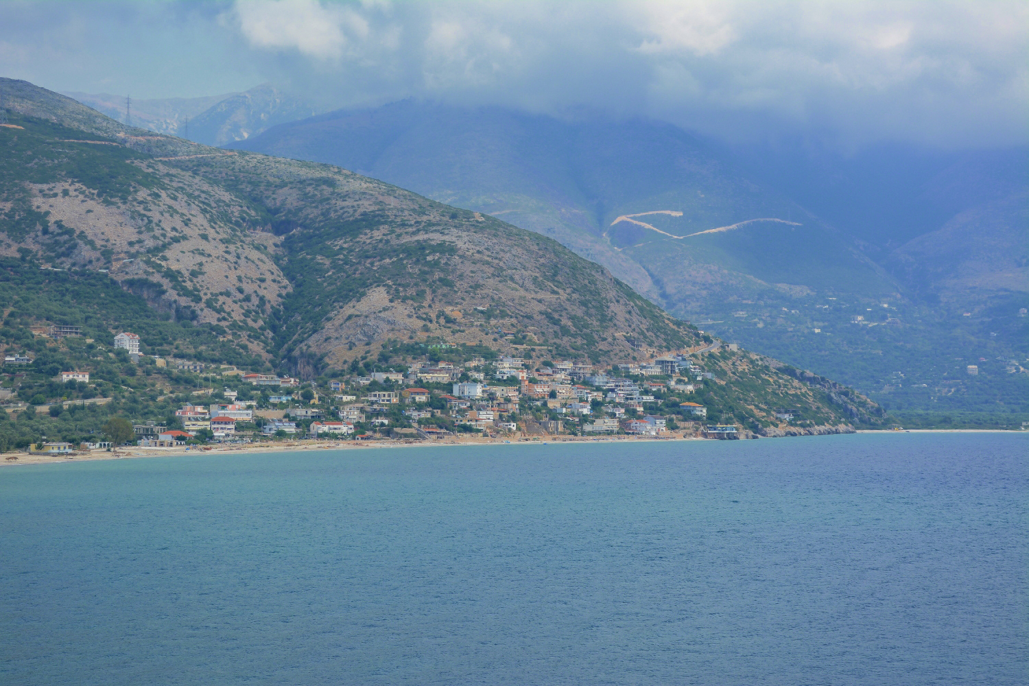 Borsh Beach Albania — long sandy and gravel shoreline backed by olive groves on the Ionian coast
