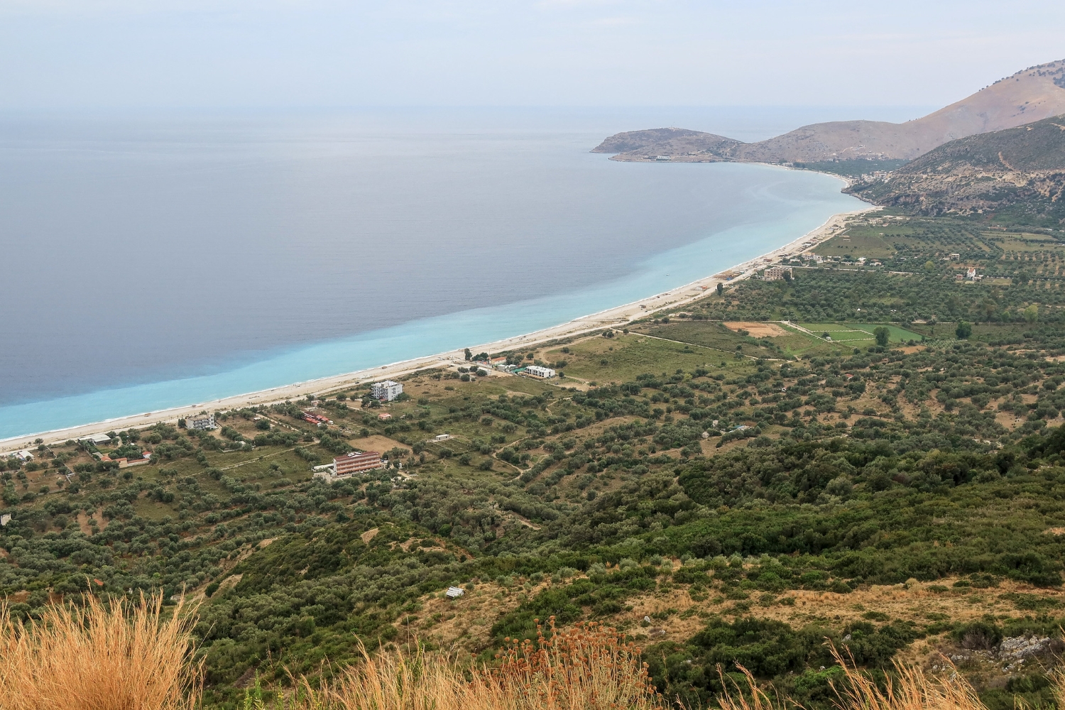 Borsh Beach Albania — wide flat pebble and sand shore stretching along the Ionian coast