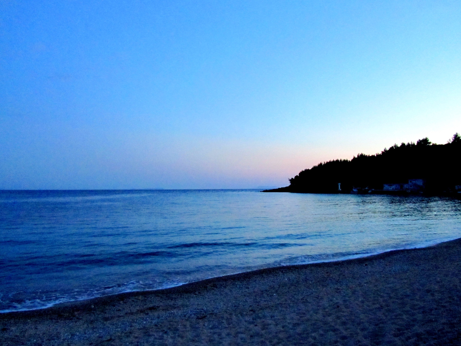 Dhërmi Beach Albania — crystal-clear turquoise water and white pebble shoreline on the Ionian coast